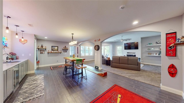 dining space featuring ceiling fan and sink