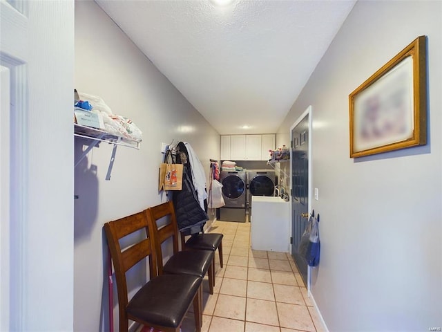 hall featuring light tile patterned floors and independent washer and dryer