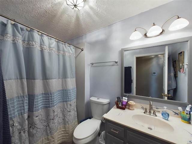 bathroom featuring a textured ceiling, toilet, a shower with curtain, and vanity