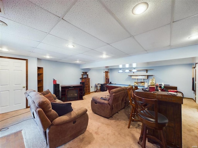 living room with light colored carpet and a paneled ceiling