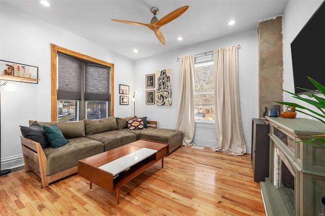 living room with ceiling fan and light wood-type flooring