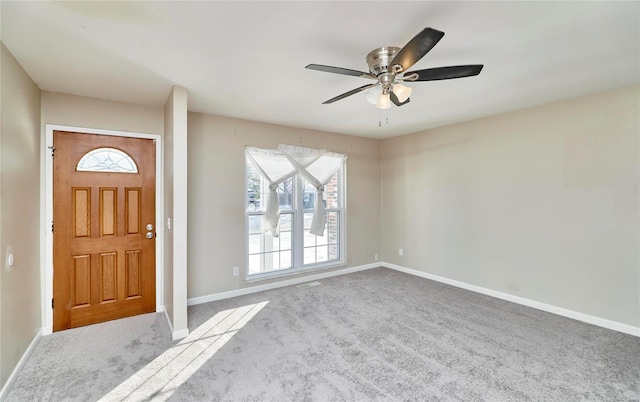 carpeted entrance foyer featuring ceiling fan