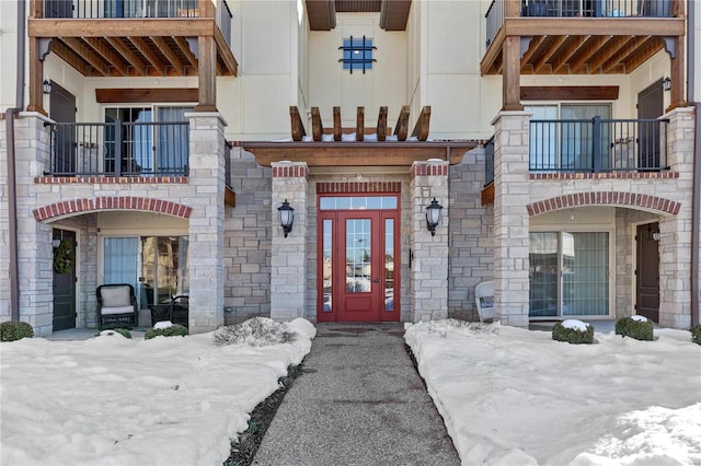 view of snow covered property entrance