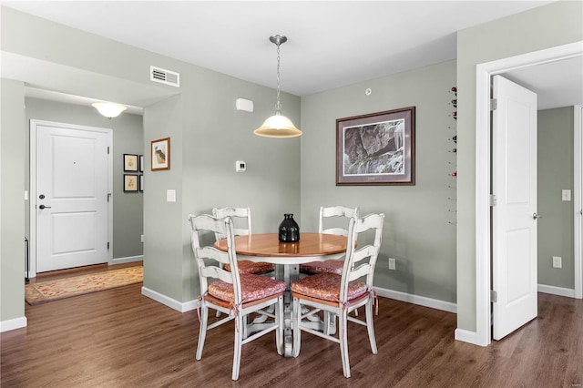 dining space with dark hardwood / wood-style floors