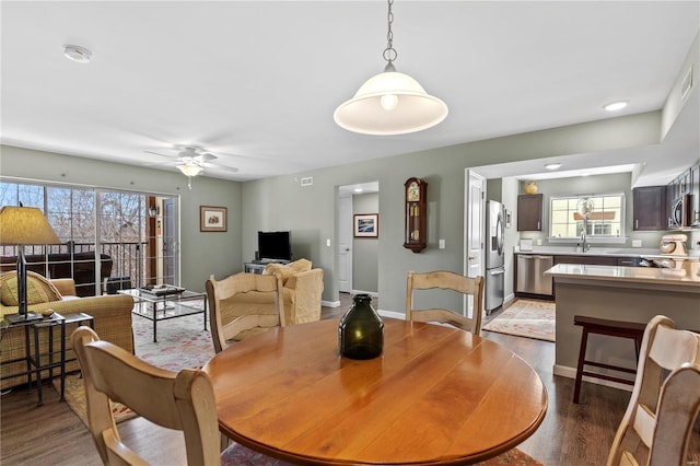 dining space featuring ceiling fan, sink, and light hardwood / wood-style floors