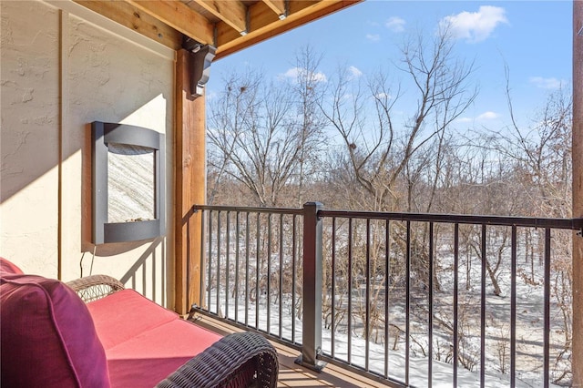 view of snow covered back of property