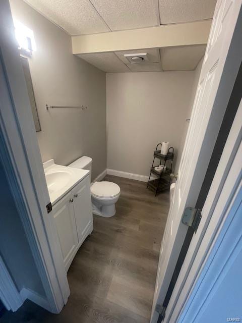 bathroom featuring toilet, vanity, and hardwood / wood-style floors