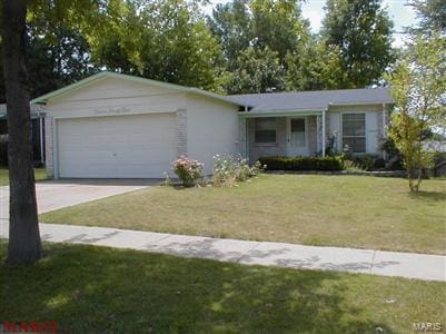 ranch-style house with a front yard and a garage