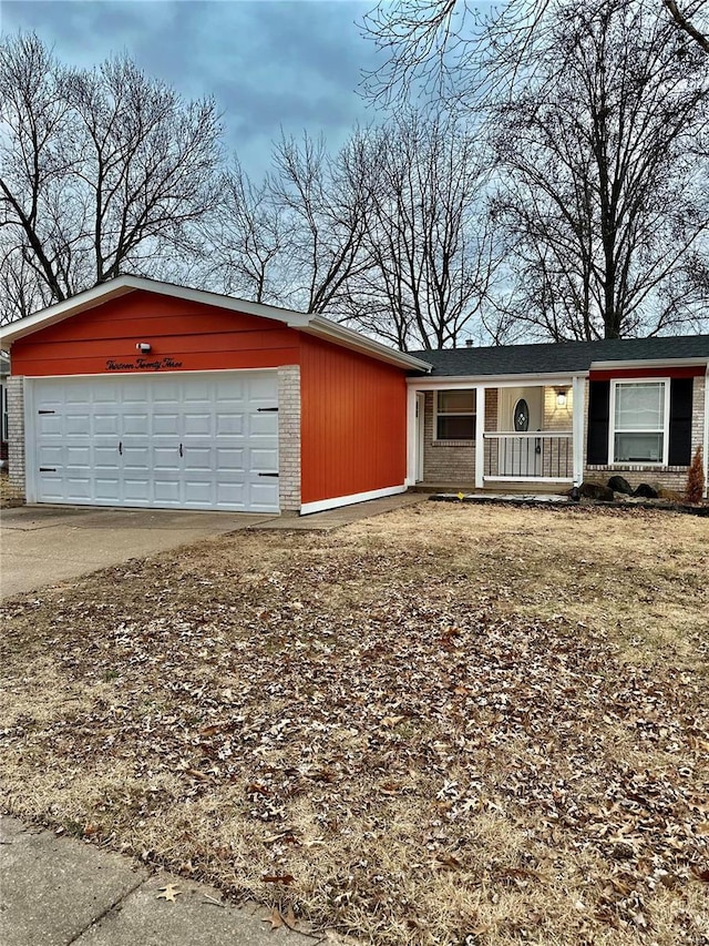 ranch-style home featuring a garage and covered porch