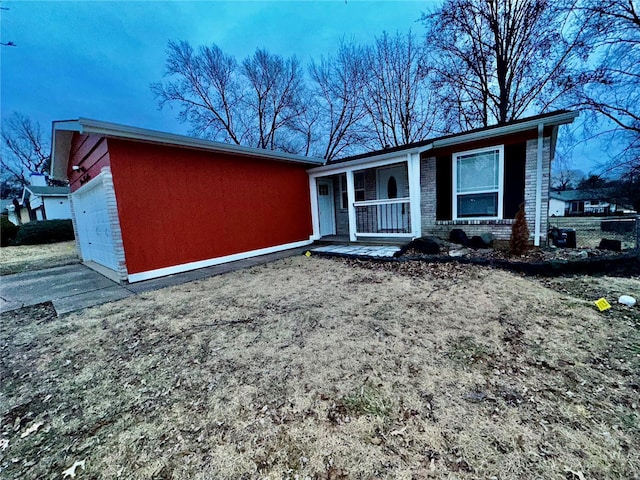 view of front of property featuring a porch and a garage