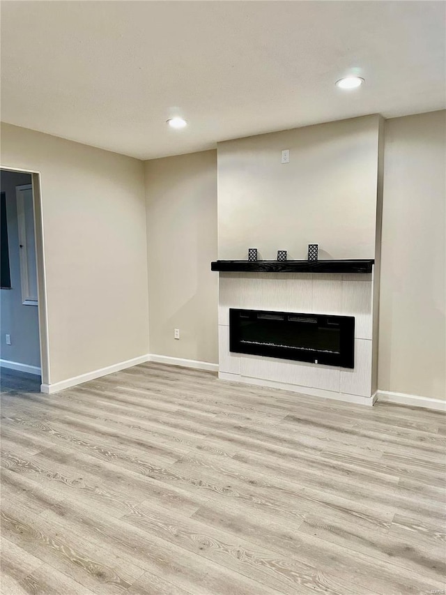 unfurnished living room with wood-type flooring