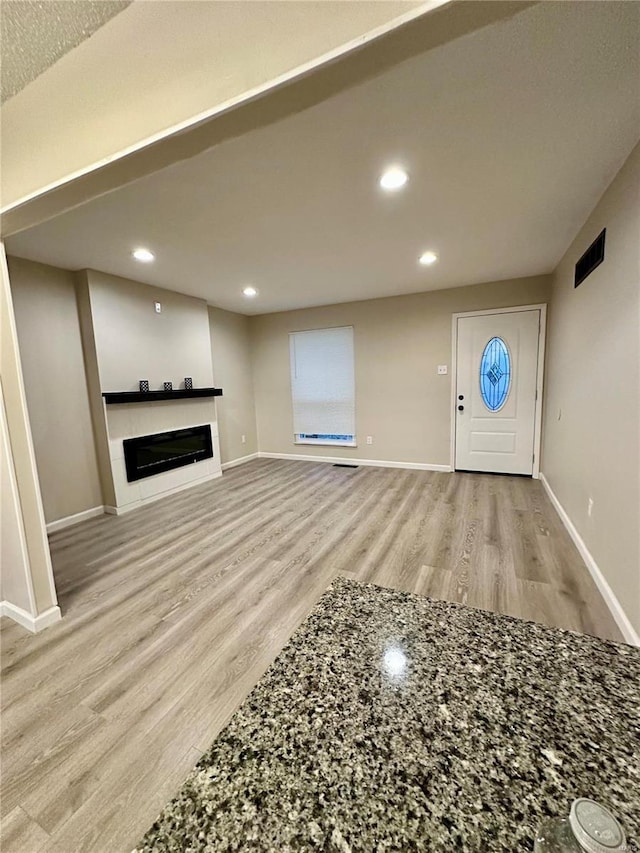 unfurnished living room featuring light wood-type flooring