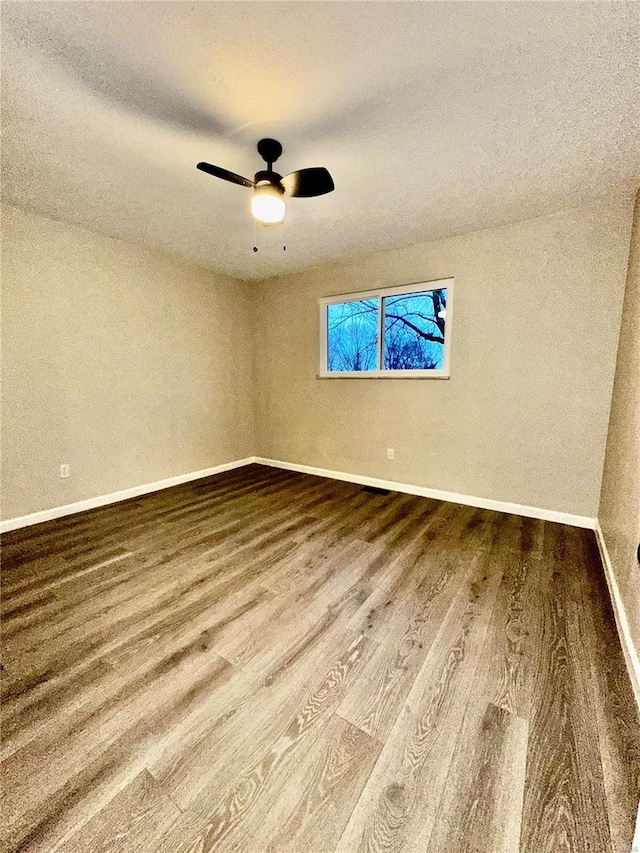 spare room with wood-type flooring and ceiling fan