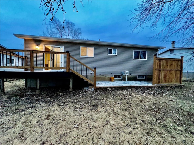 back of house featuring a deck