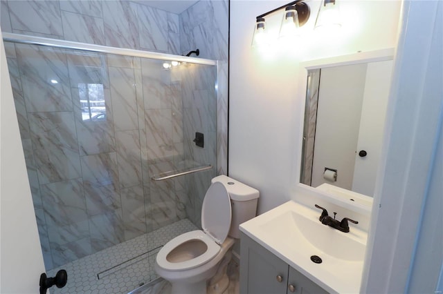 bathroom featuring a shower with shower door, toilet, and vanity