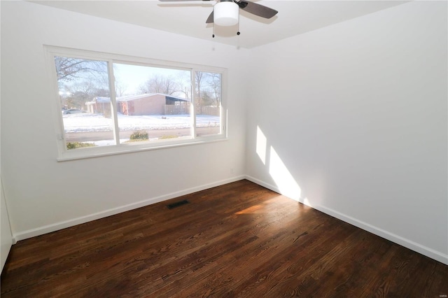 spare room featuring ceiling fan and dark hardwood / wood-style floors