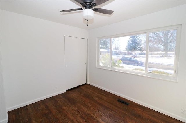 spare room featuring ceiling fan and dark hardwood / wood-style floors