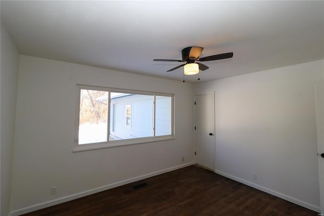 unfurnished room featuring ceiling fan and dark hardwood / wood-style floors