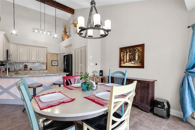 dining area with sink, a chandelier, high vaulted ceiling, light tile patterned floors, and beam ceiling