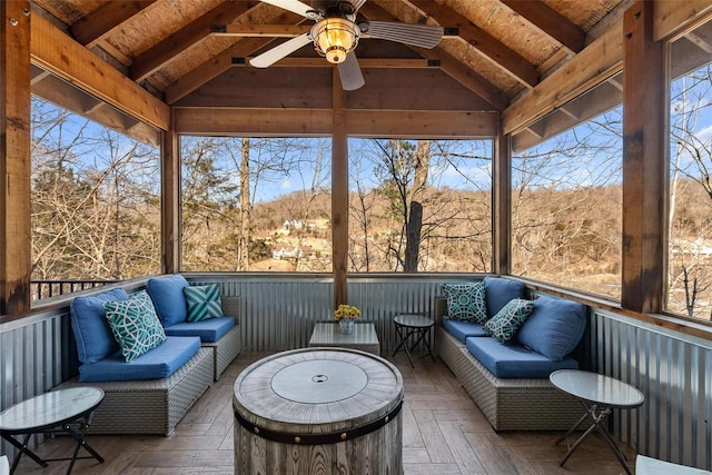 sunroom / solarium featuring ceiling fan and vaulted ceiling