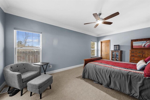 bedroom with light carpet, ornamental molding, and ceiling fan