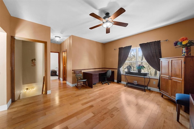 misc room with ceiling fan and light hardwood / wood-style flooring