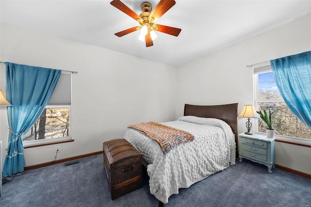 carpeted bedroom featuring ceiling fan and multiple windows