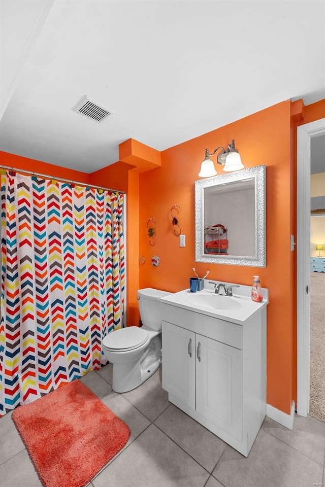 bathroom with vanity, tile patterned floors, and toilet