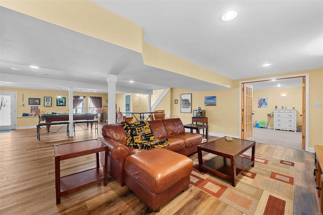 living room with ornate columns, pool table, and light hardwood / wood-style floors