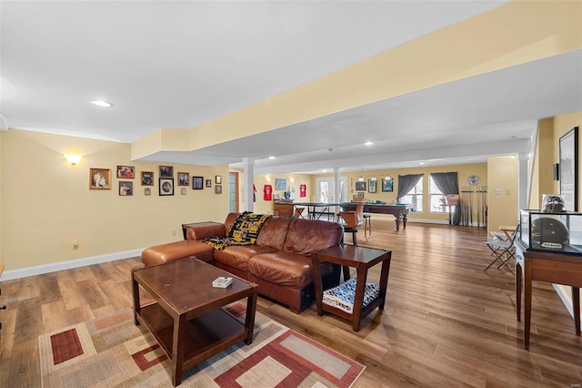 living room with ornate columns, pool table, and light wood-type flooring