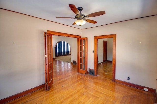 spare room featuring ceiling fan, light parquet flooring, and french doors