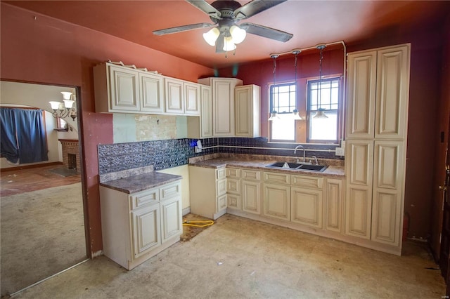 kitchen featuring decorative light fixtures, tasteful backsplash, sink, ceiling fan, and cream cabinetry