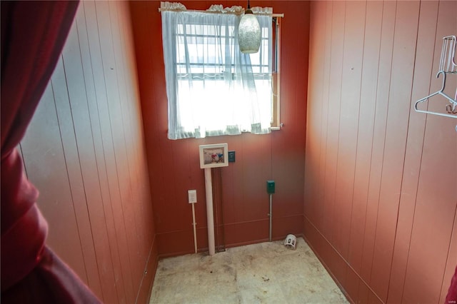 laundry area with washer hookup and wood walls