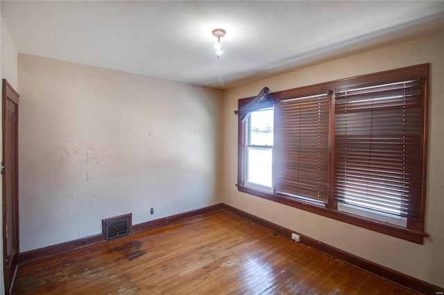 spare room with hardwood / wood-style flooring