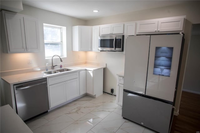 kitchen featuring sink, stainless steel appliances, and white cabinetry