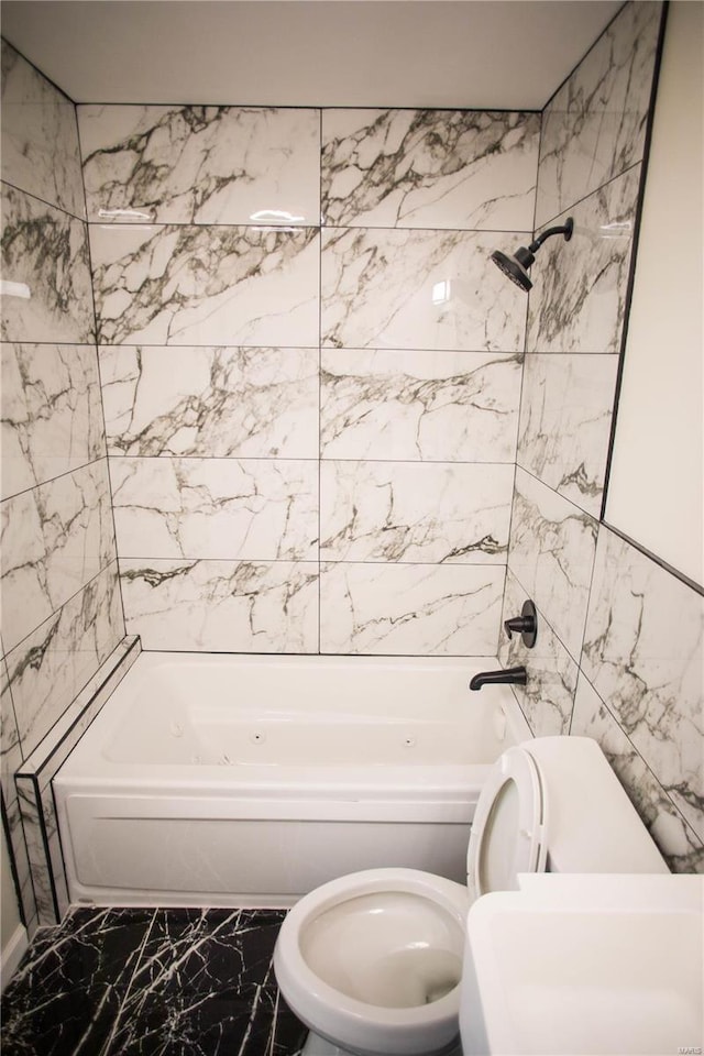 bathroom featuring toilet and  shower combination