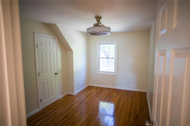 additional living space with dark hardwood / wood-style flooring