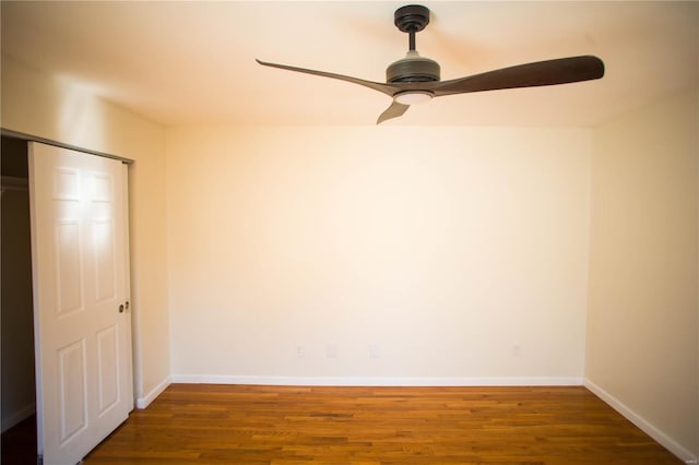 interior space featuring ceiling fan, a closet, and dark hardwood / wood-style floors