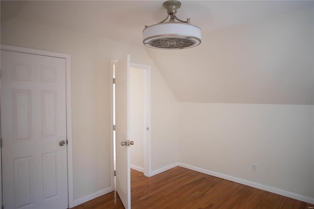 bonus room with lofted ceiling and dark hardwood / wood-style flooring