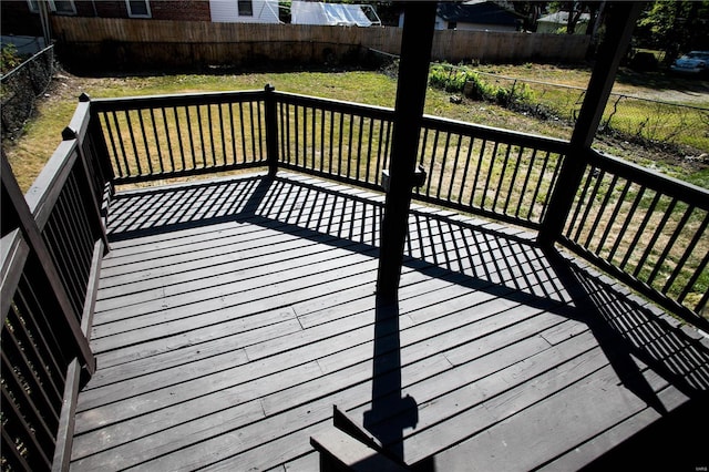 wooden deck featuring a yard