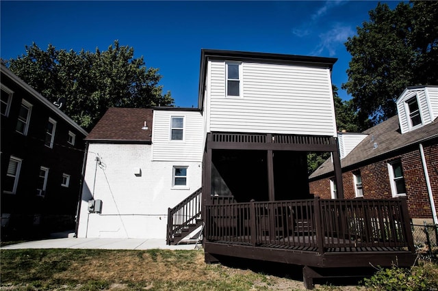 back of property featuring a patio area and a deck