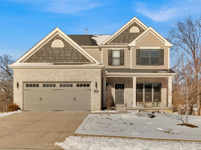 view of front of house featuring a garage, driveway, brick siding, and covered porch