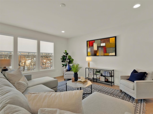 living room with baseboards, wood finished floors, and recessed lighting