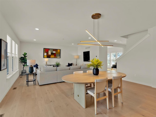 dining space with baseboards, light wood finished floors, visible vents, and recessed lighting