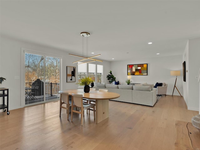 dining area with light wood-style floors, baseboards, a chandelier, and recessed lighting