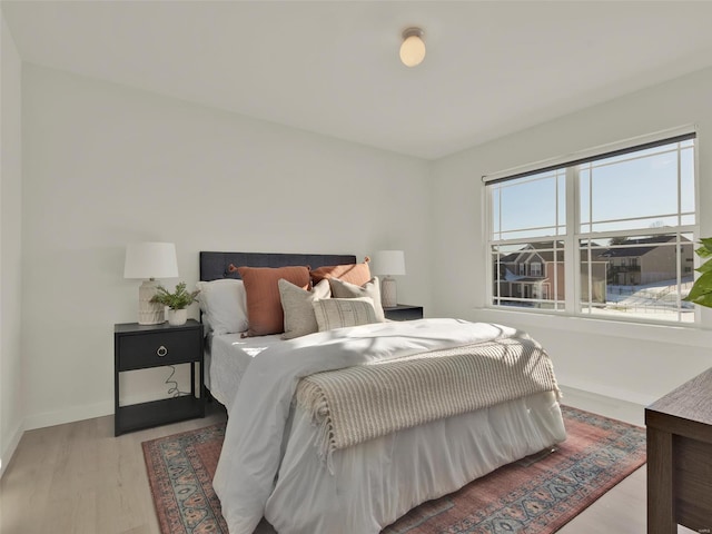 bedroom with baseboards and light wood-style floors