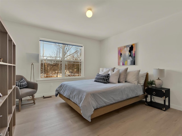 bedroom with baseboards and light wood-style floors