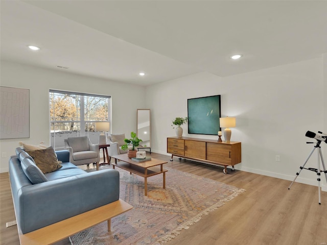 living room with recessed lighting, light wood-type flooring, visible vents, and baseboards