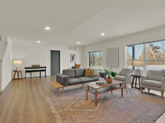 living room with light wood-style floors, recessed lighting, visible vents, and baseboards