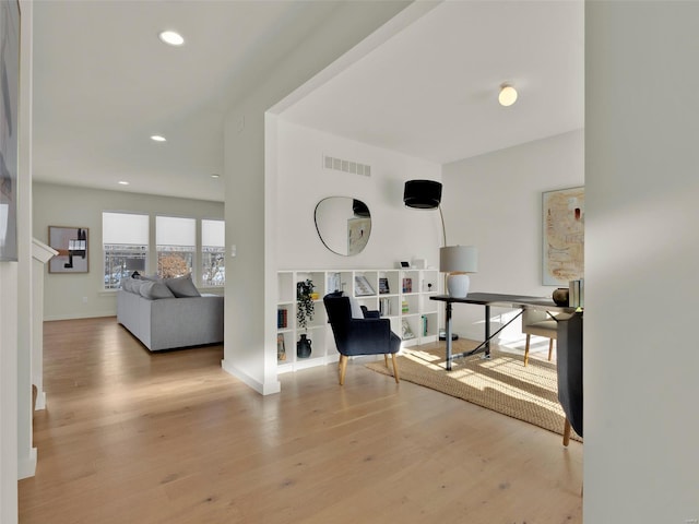 interior space featuring light wood-style floors, recessed lighting, visible vents, and baseboards